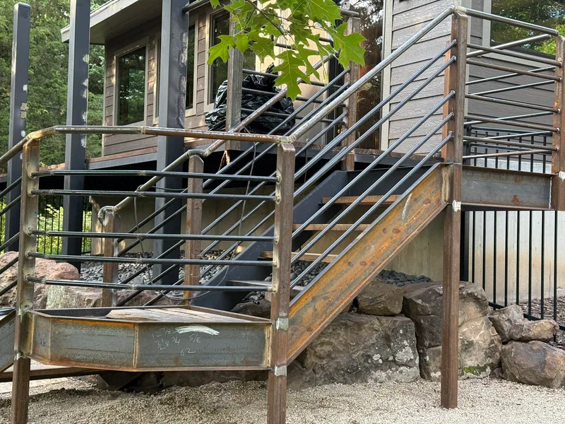 Close view of steel stair stringers, posts, landing, and railing fit-up