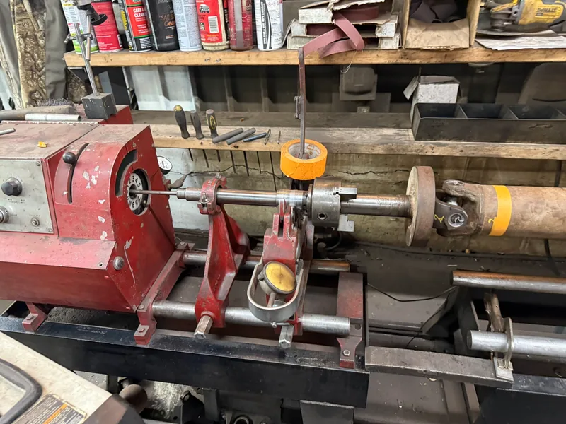 Close view of a driveshaft supported in balancing equipment