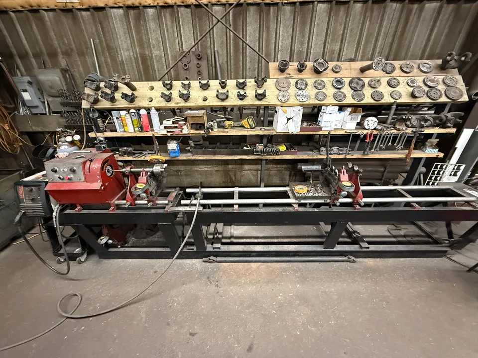 Wide view of the driveshaft balancing machine and driveline component work area