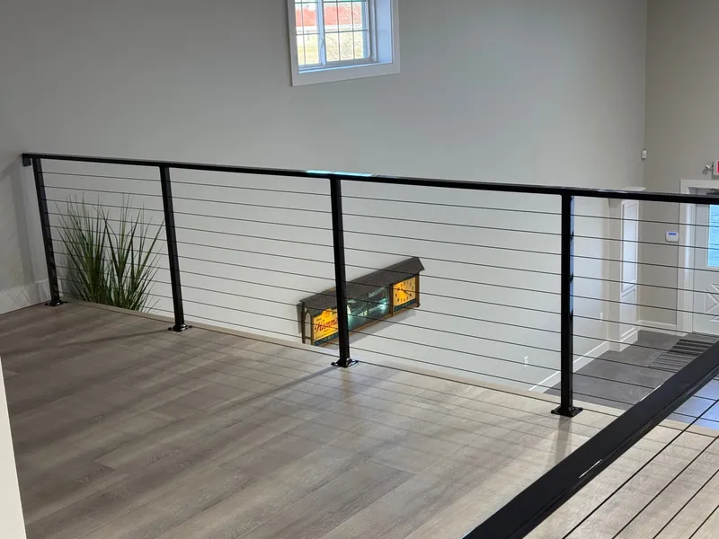 Completed cable railing along the edge of a finished loft