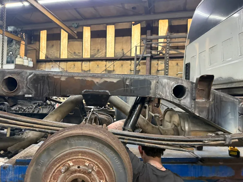 Reconstructed truck frame rail with fabricated sections and mounting points