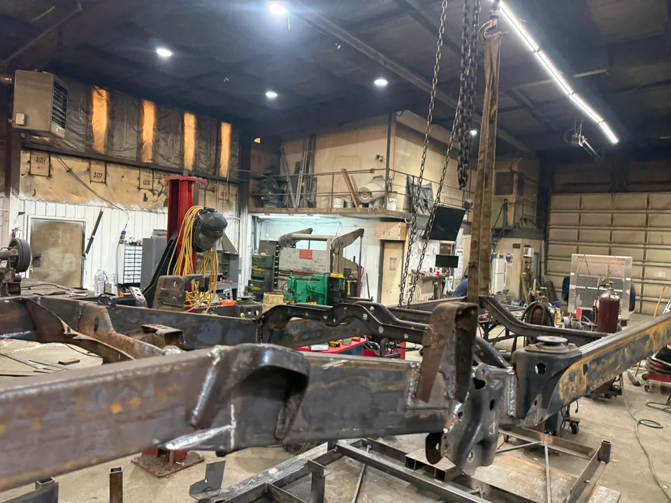 Custom truck frame fabrication in progress inside the Schmelzle MechFab shop