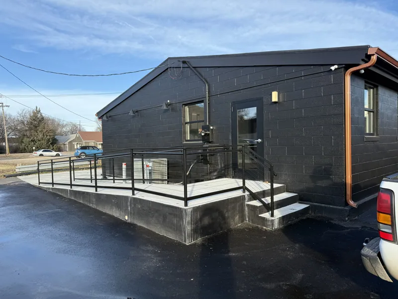 Exterior metal railing project beside a building entrance