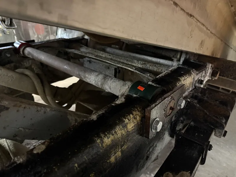 Exposed trailer frame members and a repaired structural joint beneath the trailer body