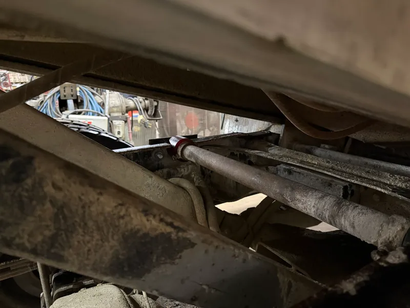 Close view of trailer frame structure beneath the trailer body during repair